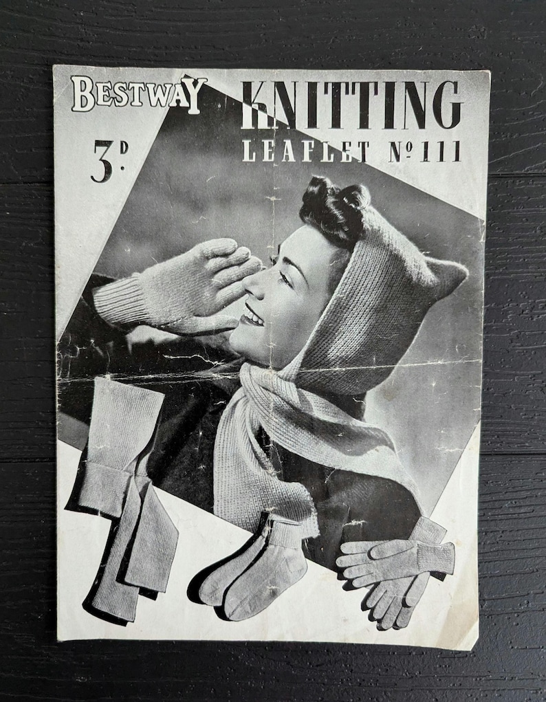 May include: A vintage Bestway Knitting Leaflet No 111 featuring a black and white photograph of a person wearing a knitted hood with ear-like points and a scarf. The leaflet also displays illustrations of knitted gloves and socks.