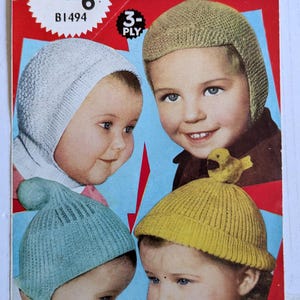 May include: Vintage advertisement for toddler knit hats. The image shows four children wearing different coloured knit hats: white, beige, blue, and yellow. The advertisement includes text that reads "TODDLERS' HELMETS" and "WELDONS KNITWEAR".