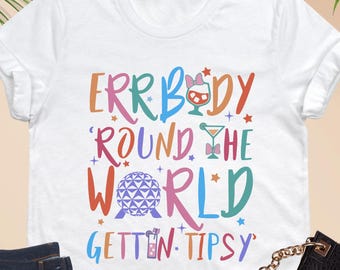 May include: White t-shirt with a colorful graphic that says "Errbody Round the World Gettin' Tipsy".
