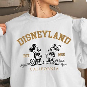 May include: A set of three ceramic mugs with a speckled, matte finish in cream, light grey, and dark grey. Each mug has a simple, minimalist design and a rounded handle.