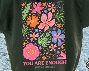 May include: A green hooded sweatshirt with a floral design and the text "YOU ARE ENOUGH JUST AS YOU ARE" on the back.