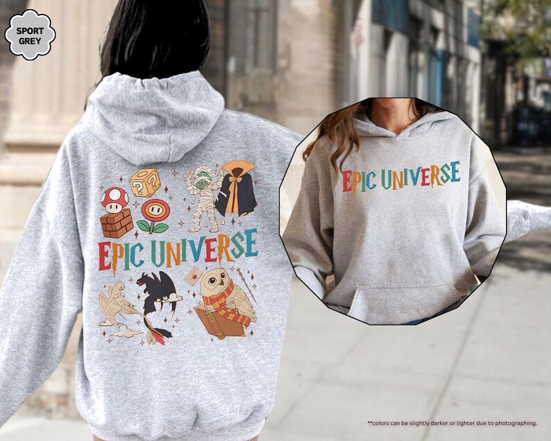 May include: A light gray hoodie with the text "EPIC UNIVERSE" in colorful letters. The back of the hoodie features various cartoon characters and the same text. The hoodie is made of a soft material and has a hood and a front pocket.