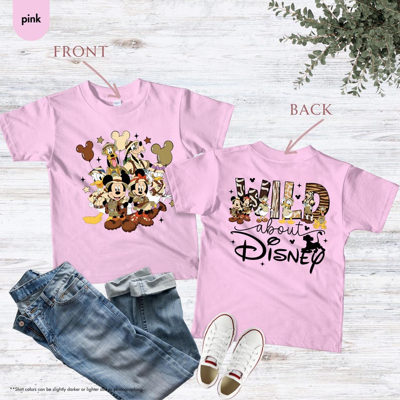 May include: Pink t-shirts with Disney characters. The front of the shirt features Mickey and Minnie Mouse, Donald Duck, and Goofy. The back of the shirt says "Wild about Disney" with a graphic of Disney characters.