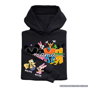 K&ouml;nnte beinhalten: Schwarzer Kapuzenpullover mit dem Wort "Mama" in bunten Buchstaben und Disney-Figuren. Der &Auml;rmel zeigt "RALPH" und "BETTY" mit Zeichentrickfiguren. Der Pullover ist schwarz.