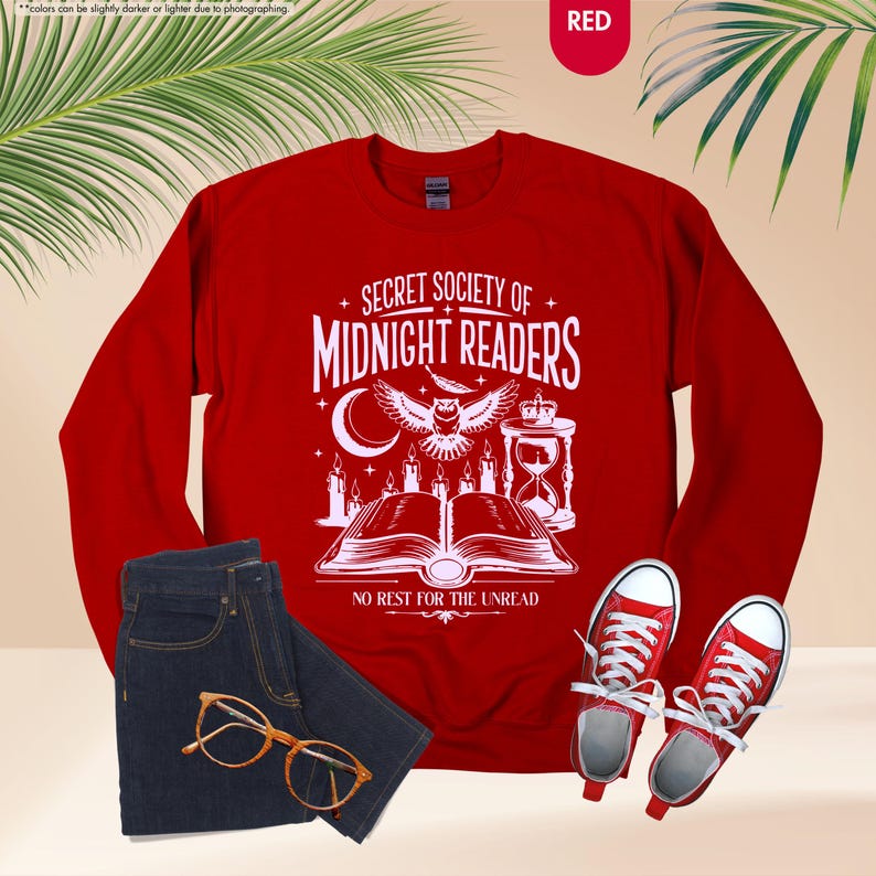 May include: A red sweatshirt with the text "SECRET SOCIETY OF MIDNIGHT READERS" and a graphic of an owl, candles, and an open book. The image also includes blue jeans, glasses, and red sneakers.