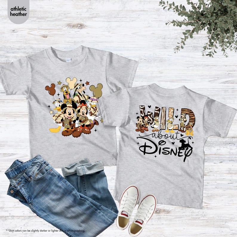 May include: Two gray athletic heather t-shirts with Disney characters, jeans, and white sneakers. One shirt features Mickey and Minnie Mouse with friends. The other says "Wild about Disney".
