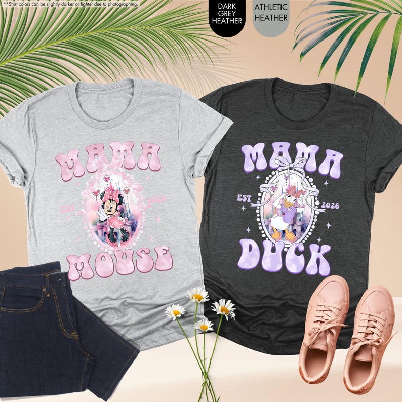 May include: Two graphic t-shirts, one gray and one dark gray, with the words "Mama Mouse" and "Mama Duck" in bubble letters. The gray shirt features Minnie Mouse, and the dark gray shirt features Daisy Duck. A pair of jeans and sneakers are also in the image.