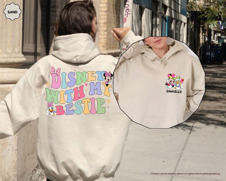 May include: Two cream colored hoodies with Disney character graphics. One hoodie says "Disney with my bestie" and features Minnie Mouse and Daisy Duck. The other hoodie says "Danielle" and features Minnie Mouse, Daisy Duck, and Donald Duck.