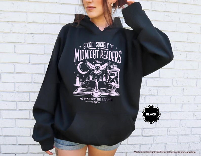 May include: Black hooded sweatshirt with a white graphic that reads "SECRET SOCIETY OF MIDNIGHT READERS" with an owl, moon, and open book design. The text "NO REST FOR THE UNREAD" is also included. The sweatshirt has a front pocket.