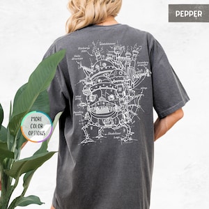 Puede incluir: Una camiseta gris oscuro con un contorno blanco de una m&aacute;quina voladora con las palabras "Watchtower", "Discharge pipe", "Helix direction", "Wind gouge", "Dwelling house", "Secondary propeller", "Wings" y "Stabilizer Legs" escritas alrededor.