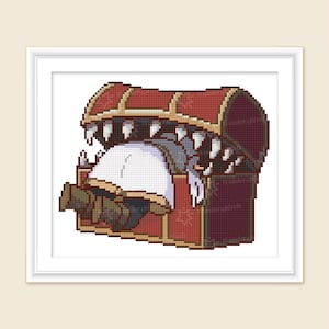 Puede incluir: Un cofre de madera rojo con una boca de monstruo dentada abierta, revelando una pequeña criatura gris en el interior.