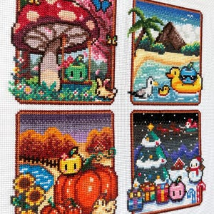 May include: A cross-stitch embroidery featuring four distinct seasonal scenes. The top left shows a mushroom and a green character on a swing. The top right depicts a beach with a palm tree and a duck float. The bottom left displays pumpkins and sunflowers. The bottom right shows a winter scene with a Christmas tree, gifts, and a snowman.