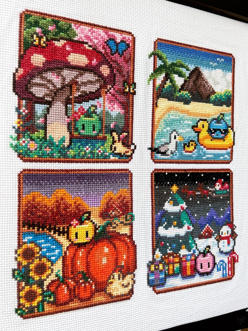 May include: A cross-stitch embroidery featuring four distinct seasonal scenes. The top left shows a mushroom and a green character on a swing. The top right depicts a beach with a palm tree and a duck float. The bottom left displays pumpkins and sunflowers. The bottom right shows a winter scene with a Christmas tree, gifts, and a snowman.