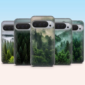 May include: A collection of phone cases featuring a forest scene with tall green trees and a misty atmosphere. The cases have a clear border and a landscape design. The cases are displayed against a gradient blue background.