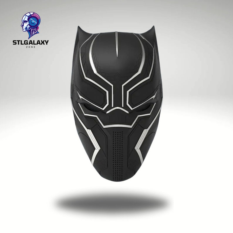 May include: Black and silver 3D printed Black Panther mask. The mask has a detailed design with a textured surface.
