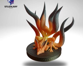 May include: A 3D printed figurine of a nine-tailed fox, also known as a kitsune, with orange and black fur. The fox is sitting on a circular base with a textured surface.