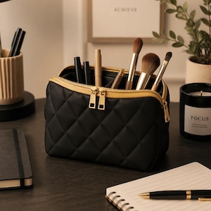 May include: A white ceramic mug with a black handle and the text "But First, Coffee" in a black, bold font. The mug is on a white surface.