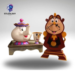 May include: A set of three ceramic figurines from the Disney movie Beauty and the Beast. The set includes Mrs. Potts, the teapot, Chip, the teacup, and Cogsworth, the clock. The figurines are painted in bright colors and have detailed facial features.