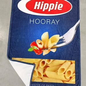 May include: A blue and yellow box with the words "Hippie Hooray" and "Master of Pasta" printed on it. The box features a picture of pasta on a fork with a red pepper and basil.