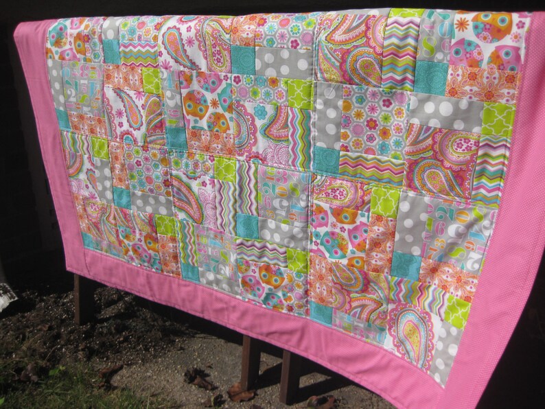 Bright Owls baby quilt in pink teal white and lime green yellow