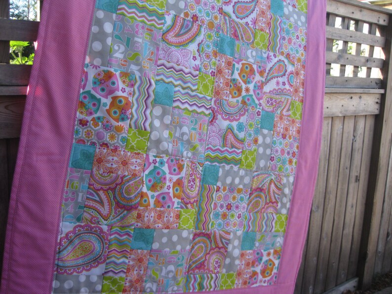 Bright Owls baby quilt in pink teal white and lime green yellow