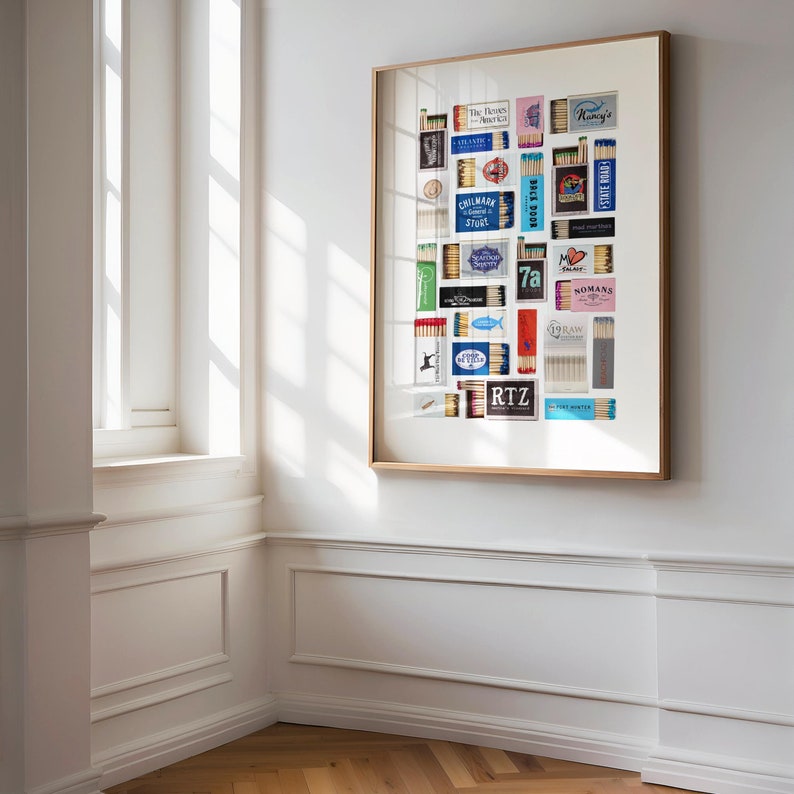 May include: A framed collage of vintage matchbox labels, featuring a variety of designs and colors. The labels include names like "The Rovers", "Gillmark", "Seafoods Delights", "7a", "Nomans", "Raw", "RTZ", and "The First Hunter".