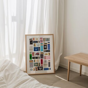 May include: A framed collage of matchbox labels, featuring a variety of designs and colors. The labels include text such as "SEDAT", "LEVEL", and "BARBERSHOP".