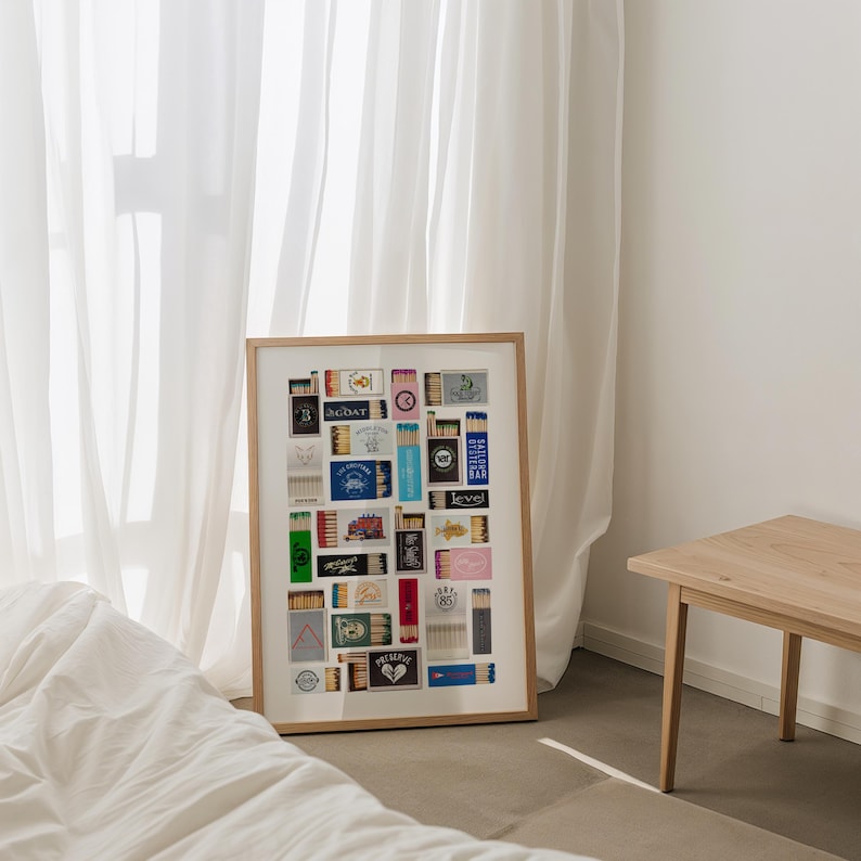 May include: A framed collage of matchbox labels, featuring a variety of designs and colors. The labels include text such as "SEDAT", "LEVEL", and "BARBERSHOP".