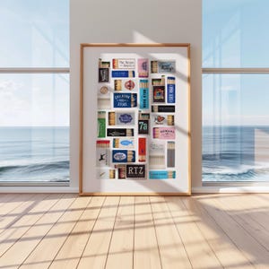 May include: A framed collage of matchboxes with various designs and text, including "The Reves of America", "Chilmark Store", "Back Door", "State Roads", "7a", "Nomans", "19 Raw", and "RTZ".