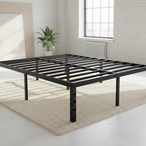 May include: A black metal bed frame with a slatted design, resting on a beige rug. The frame has adjustable legs and is in a bright, airy room with large windows and plants.
