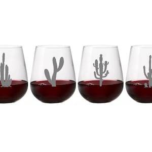 May include: Set of four clear glass wine glasses with cactus silhouettes etched on the front. Each glass is filled with red wine.