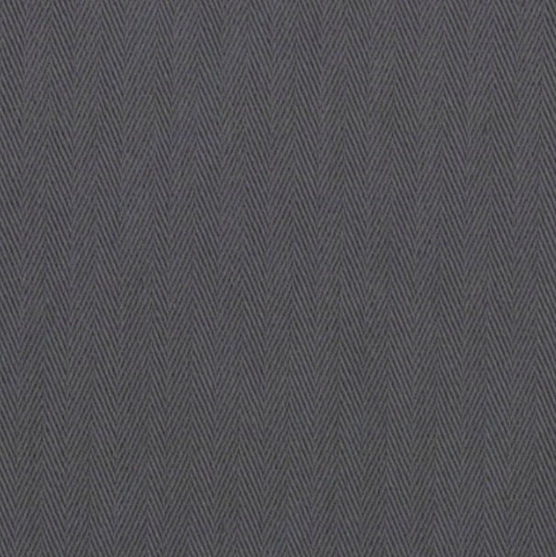 May include: Close-up of a charcoal gray herringbone fabric. The fabric has a textured appearance with a repeating V-shaped pattern. The weave creates a subtle visual depth, suitable for apparel or upholstery.