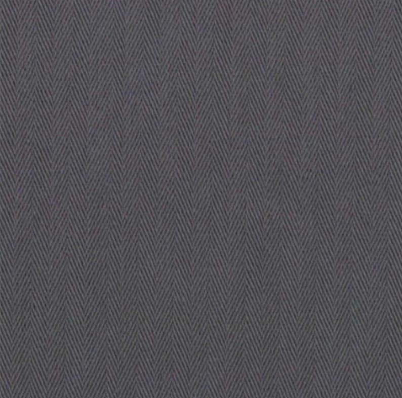 May include: Close-up of a gray herringbone fabric. The fabric has a repeating V-shaped pattern, with the lines running diagonally across the material. The color is a muted gray, with subtle variations in tone, creating a textured appearance.
