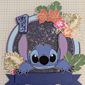 May include: A blue Stitch character from Lilo & Stitch peeks over a blue banner with a glittery, black background. The banner has a blue circle with a glittery number one in the top left corner. The background is a white grid.
