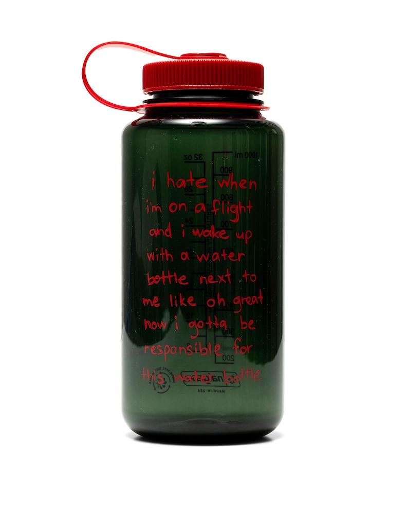 May include: A green water bottle with a red cap and loop. The bottle has red text that reads "I hate when I'm on a flight and I wake up with a water bottle next to me like oh great now I gotta be responsible for".