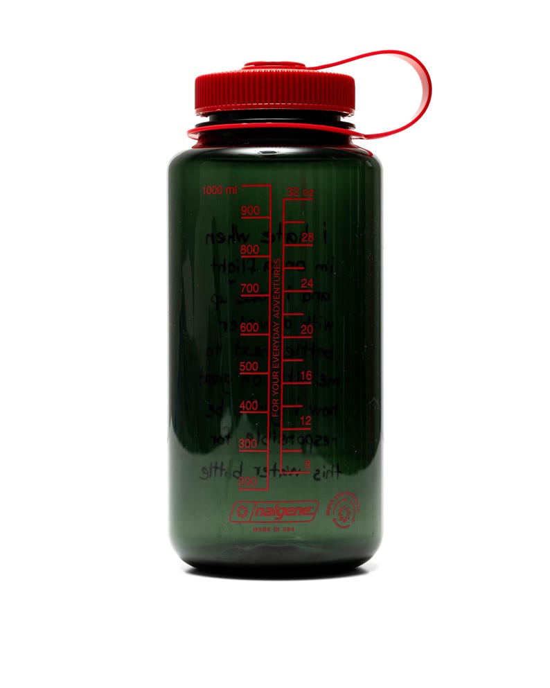 May include: A dark green water bottle with a red cap and handle. The bottle has a clear, graduated scale in red, marked in milliliters and ounces. The text "FOR YOUR EVERYDAY ADVENTURES" is printed on the side. The bottle is made by Nalgene.