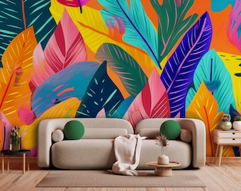May include: A living room interior design with a white sofa and colorful tropical leaf patterned wallpaper. The sofa has two green throw pillows and a white throw blanket. There is a small wooden table with a plant and a wooden side table with two potted plants.