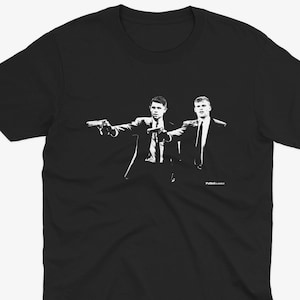 May include: Black t-shirt with a white silhouette of two men pointing guns at each other. The text "Pulp Fiction" is printed below the image.