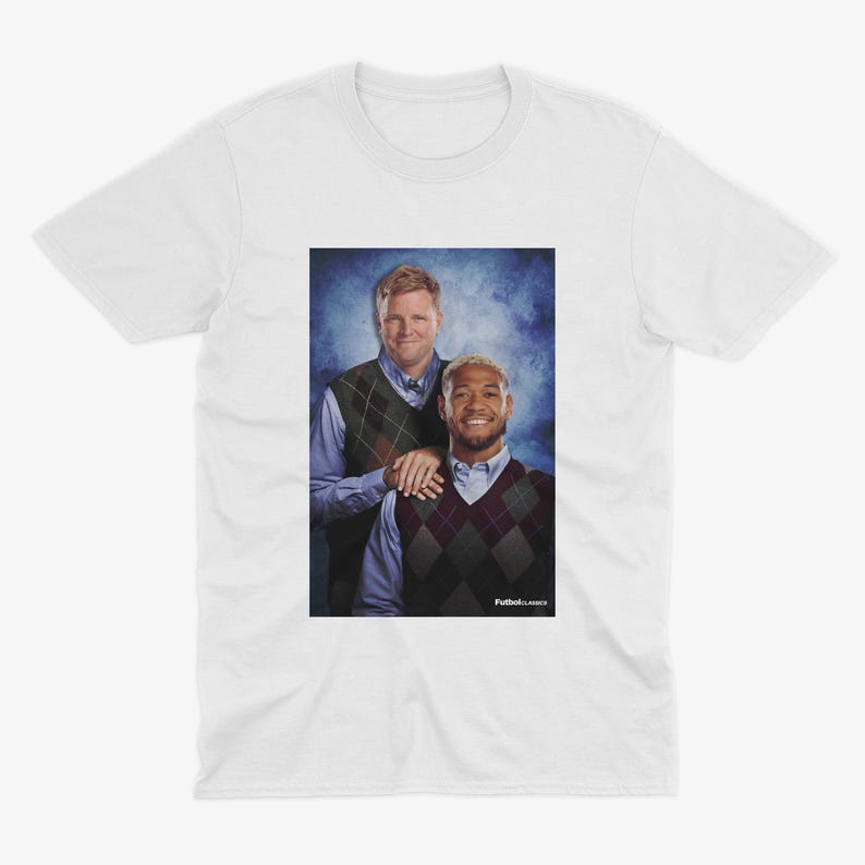 May include: A white t-shirt with a photo of two men wearing sweaters. The men are standing in front of a blue and white background. The text "Fullback Classics" is printed on the bottom of the photo.