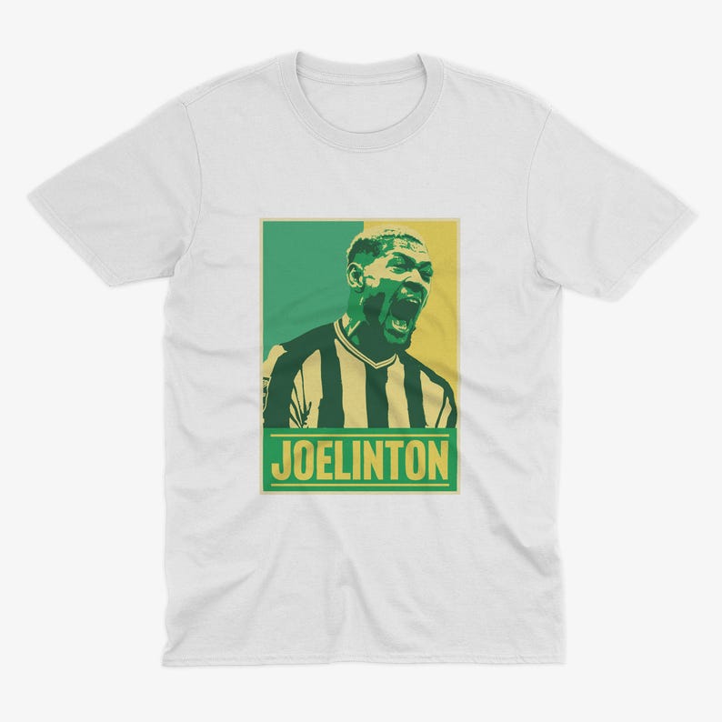 May include: White t-shirt with a green, yellow, and black graphic of a soccer player with the text "JOELINGTON" in yellow.