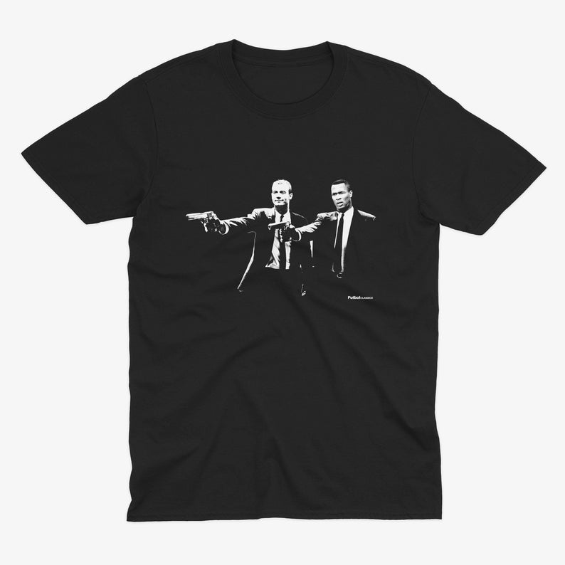 May include: Black t-shirt with a white graphic of two men in suits holding guns. The text "Pulp Fiction" is printed below the graphic.