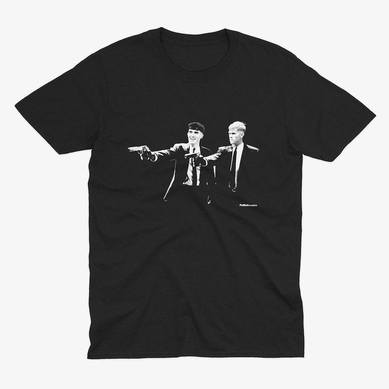 May include: Black t-shirt with a white image of two men in suits holding guns. The text "Pulp Fiction" is printed in small white letters at the bottom of the image.