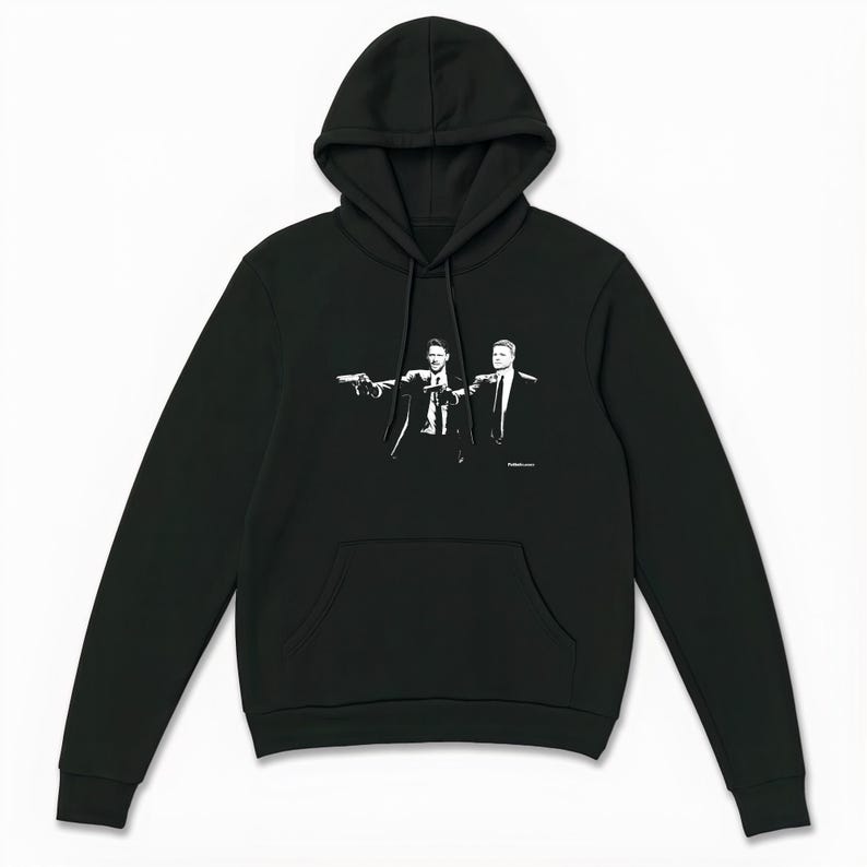 May include: Black hoodie featuring a white graphic of two men in suits pointing guns. The hoodie has a drawstring hood and a front kangaroo pocket. The design is a stylized illustration.