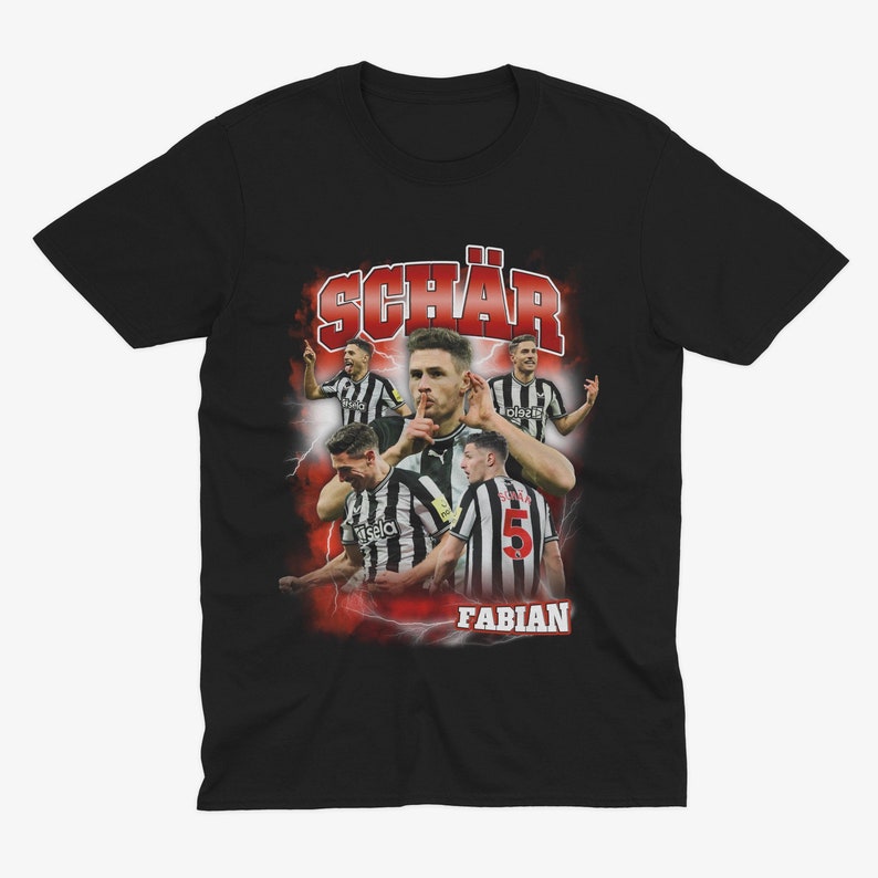May include: Black t-shirt featuring a retro-style graphic of a football player, Fabian Sch&auml;r, wearing a black and white kit. The graphic includes the text "Sch&auml;r" and "Fabian".