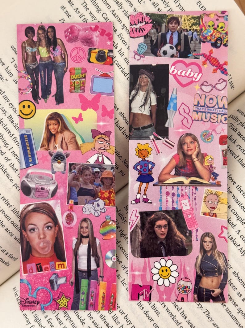 May include: Two pink bookmarks decorated with images of celebrities, stickers, and text. One bookmark features a photo of Britney Spears blowing a bubble, and the other has the text "NOW THAT'S WHAT I CALL MUSIC".
