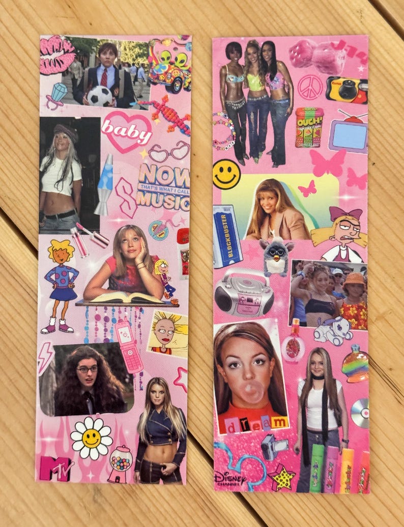 May include: Two pink rectangular bookmarks with various images and text. One bookmark features the word "baby" and "NOW THAT'S WHAT I CALL MUSIC". The other bookmark has the word "dream" and the Disney Channel logo.