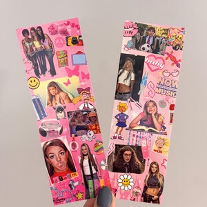 May include: Two pink bookmarks decorated with images of pop culture icons, including singers and cartoon characters. The bookmarks have a collage design with various images and text, creating a nostalgic aesthetic.