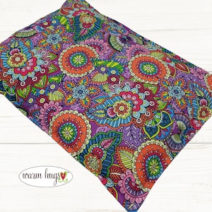 May include: A purple, blue, green, orange, and pink patterned fabric with a paisley design. The fabric is soft and comfortable and is perfect for making pillows, blankets, and other home decor items.