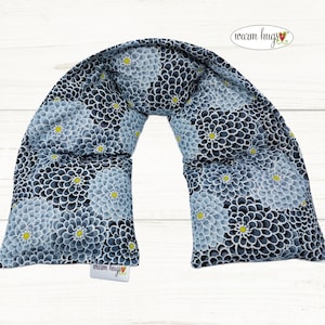 May include: A blue and white floral patterned neck wrap with the text "warm hugs" on the bottom.