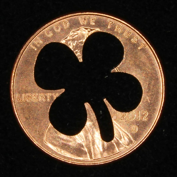 Lucky penny with four leaf clover cut out